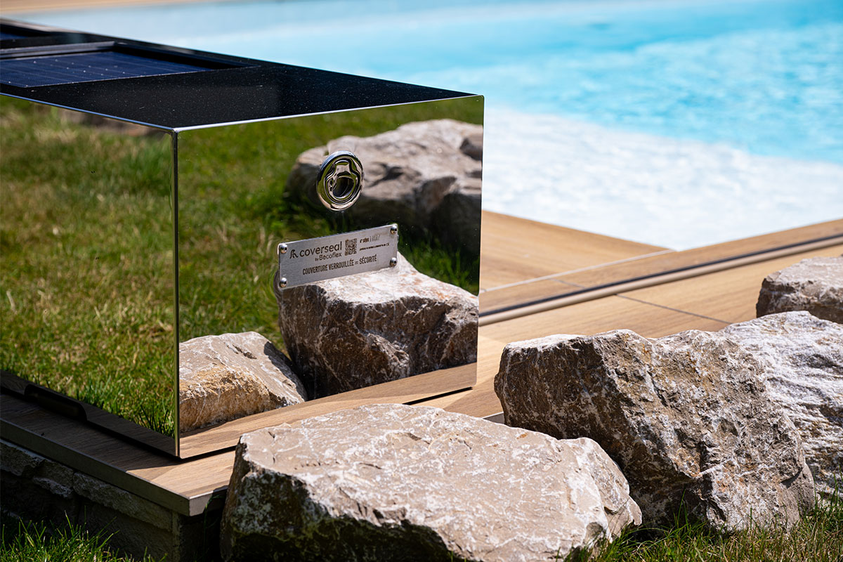 DreamHomeFamily9 Détail rapproché de l'habillage effet miroir Coverseal installé au bord de la piscine, reflétant élégance et robustesse.